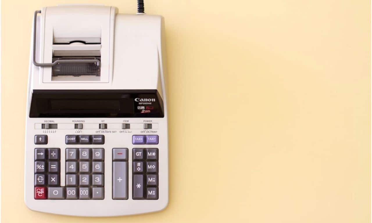 A calculatorreceipt printer represents the importance of tracking project financials.