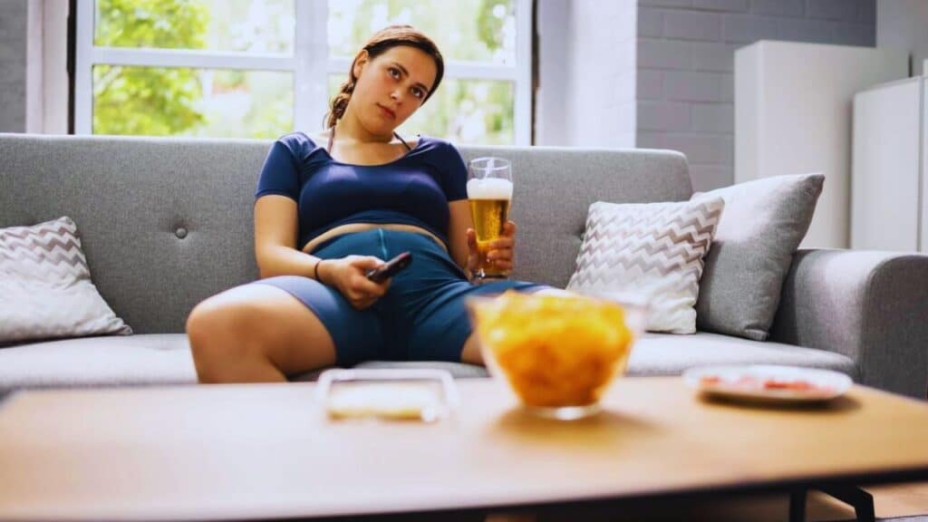 Overeating Junk Food, Drinking Beer And Watching TV