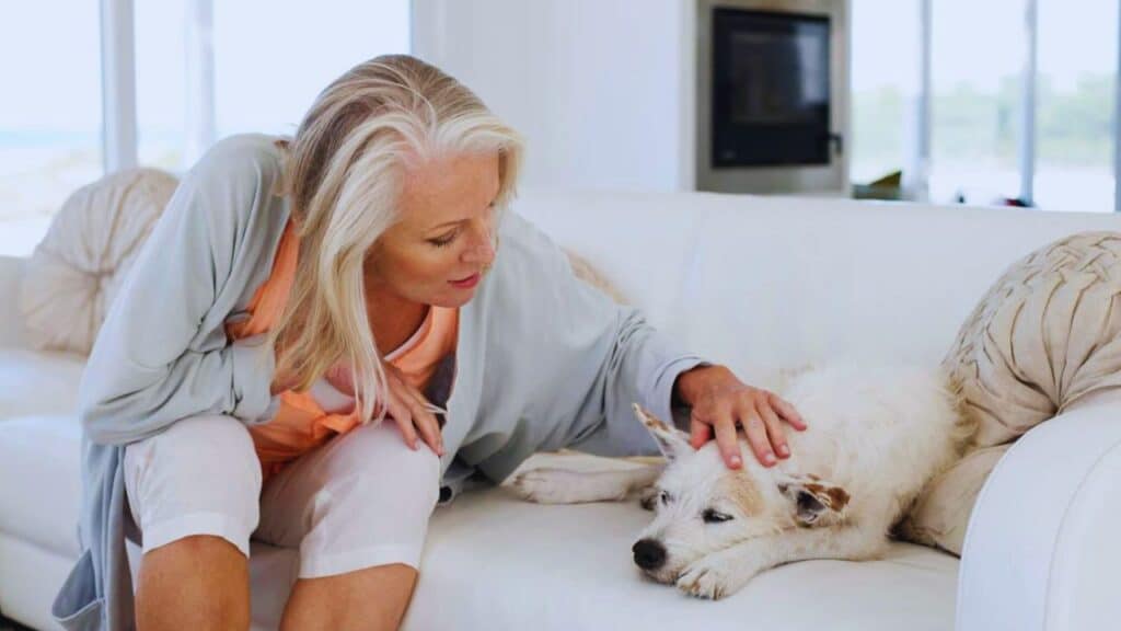 Woman sitting on a couch with her dog