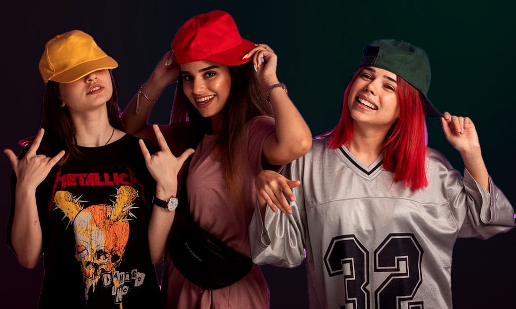 Three women wearing caps, each showcasing distinct fashion styles.