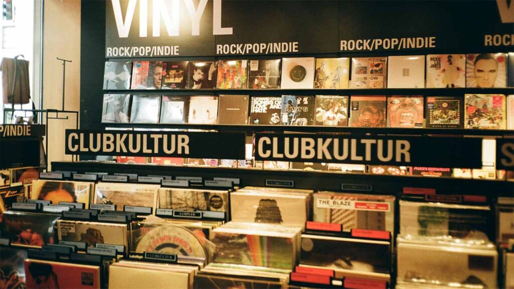 Vinyl record store with sections for rock, pop, indie, and club music.