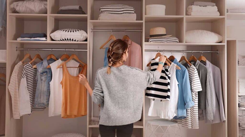 Woman standing in front of an open wardrobe