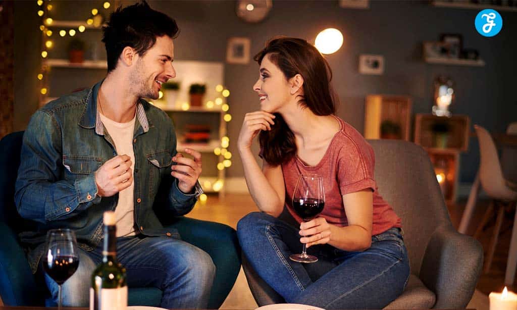 A couple enjoying a conversation with wine