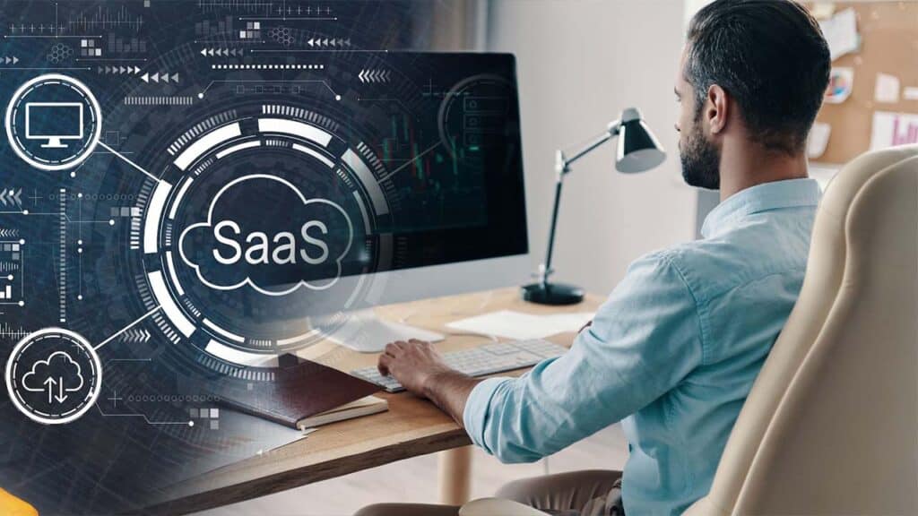 Man working at a desk with SaaS (Software as a Service)
