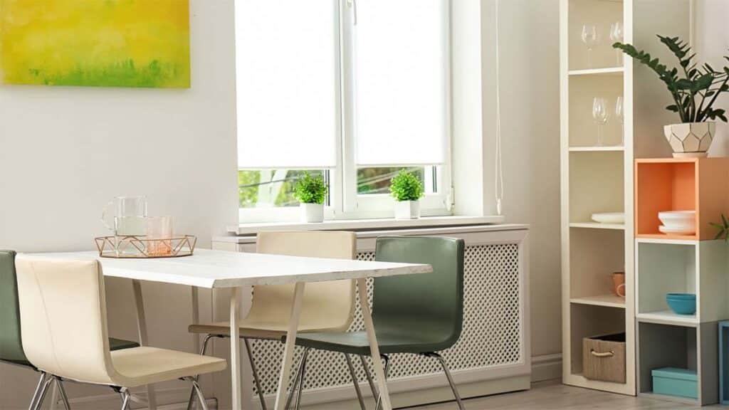 Modern dining area with a white table, mixed chairs