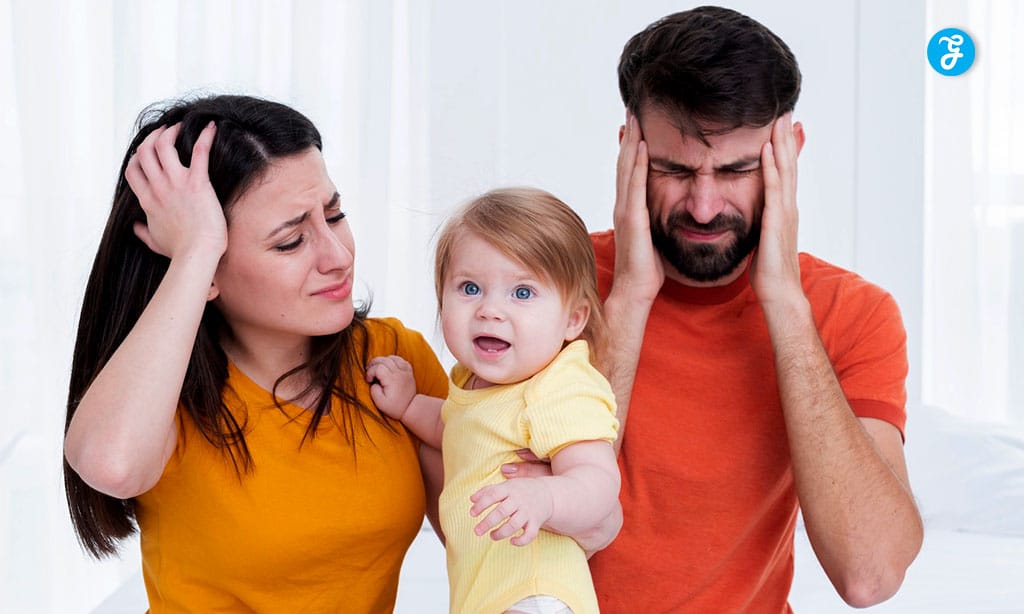 Frustrated parents with a confused toddler during a stressful moment
